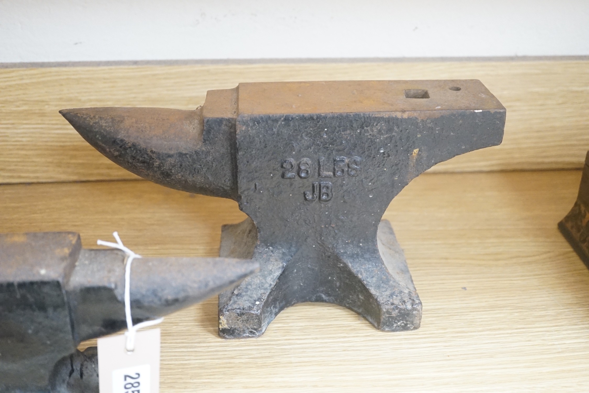 Two cast iron anvils, largest 32cm long and 28lbs
